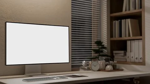 A computer with a white screen mockup on a table against the wall in a mini.. イラスト素材