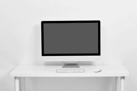 Computer on a white table Stock Photos