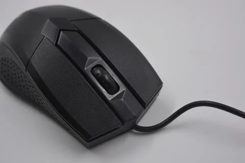 A computer, wired mouse with a long wire and a USB connection. Stock Photos