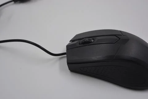 A computer, wired mouse with a long wire and a USB connection. Stock Photos