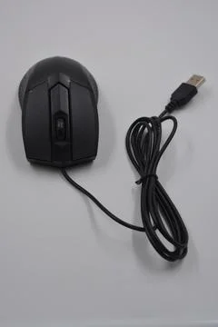 A computer, wired mouse with a long wire and a USB connection. Stock Photos