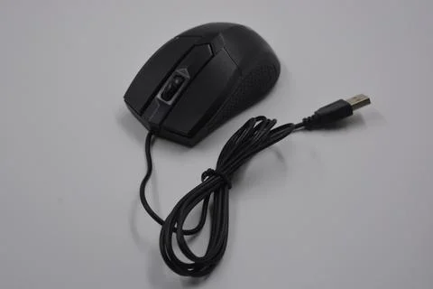 A computer, wired mouse with a long wire and a USB connection. Stock Photos