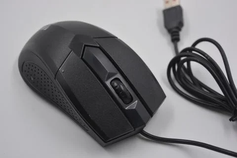 A computer, wired mouse with a long wire and a USB connection. Stock Photos