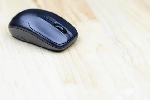 Computer wireless mouse on wood table for business, education and technology Stock Photos