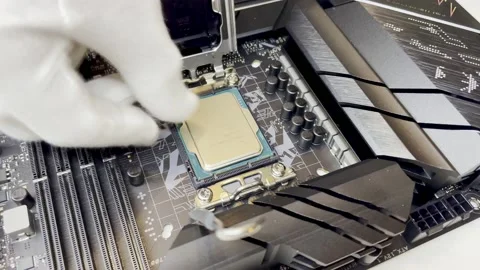 The computer wizard installs a new processor into the motherboard Stock Footage 237953671