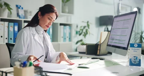 Computer, woman and doctor with documents in clinic for research on diagnosis or Stock Footage 311086181