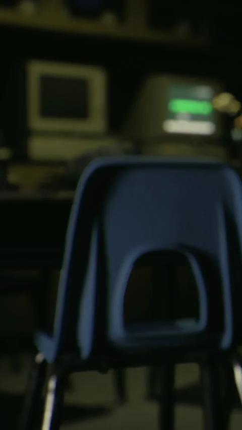 Computer workstation with empty chair and screens set in dark room Stock Footage 330440804