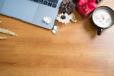 Computer, xmas gift box, coffee cup on wood table. christmas and new year hol Stock Photos