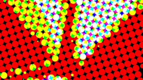 Computerized animation of small white and yellow circles revolving on red Video stock 132479365