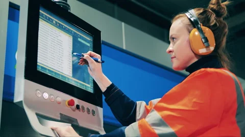 Computerized console is being operated by a female engineer Video stock 147644904