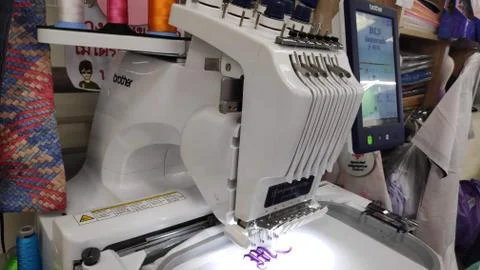 Computerized embroidery machine Sewing machine while operating textile. Stock Photos