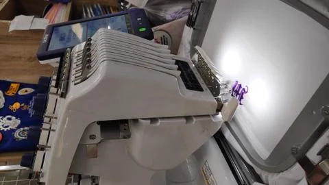 Computerized embroidery machine Sewing machine while operating textile. Stock Photos