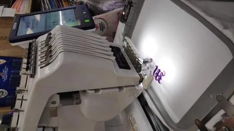 Computerized embroidery machine Sewing machine while operating textile. Stock Photos