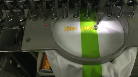 Computerized embroidery machine, working on lacing Thai text on T-shirt Stock Footage 47412743