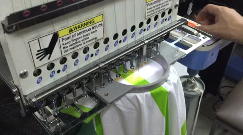 Computerized embroidery machine, working on lacing Thai text on T-shirt Video stock 47786511