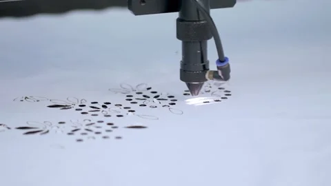 Computerized laser cutting machine making flower pattern on a cloth at warehouse Stock Footage 136122614