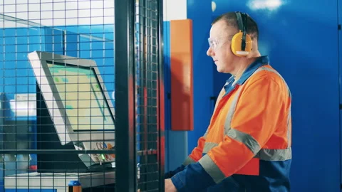 Computerized machine is getting operated by a factory worker Video stock 147648276