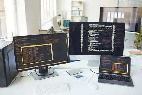 Computers with Code on Screen in IT Development Office 스톡 사진