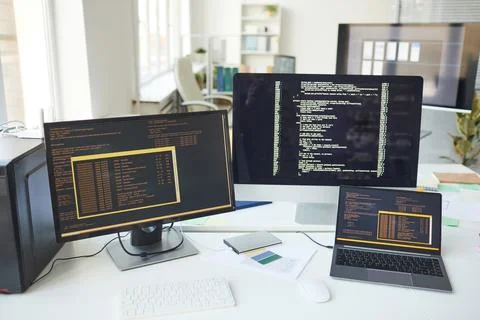 Computers with Code on Screen in IT Development Office Stock Photos