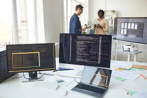 Computers with Code on Screen in IT Office Stock Photos