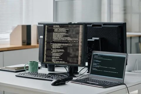 Computers with codes in modern office Stock Photos