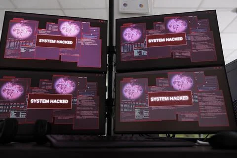 Computers displaying hacked system alert message flashing on monitor Stockfoto's