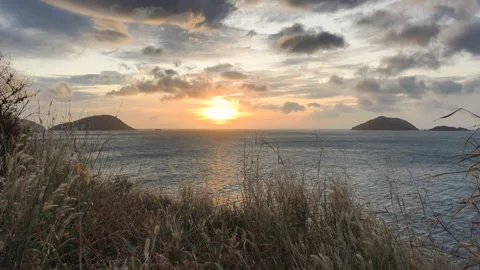Con Dao Sunset creates calm mood. People watch Con Dao Sunset from coastal road Stock Footage 326851991