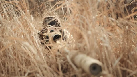 Concealed Sniper in Dry Grass Awaiting the Perfect Moment for a Precision Shot Stock Footage 269017969
