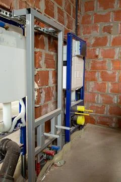 Concealed toilet installation frame inside unfinished brick wall background 写真素材