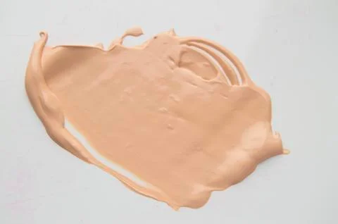 Concealer, light beige makeup, smear cream base, Foundation on white backgrou Foto stock