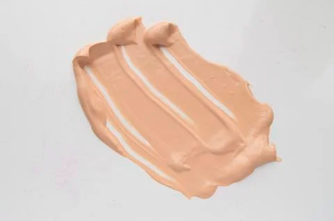 Concealer, light beige makeup, smear cream base, Foundation on white backgrou Stock Photos