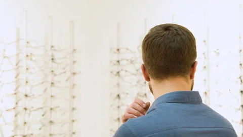 Conceived man choosing glasses at optics store. Health care, eyesight and vision Stock Footage 231680429