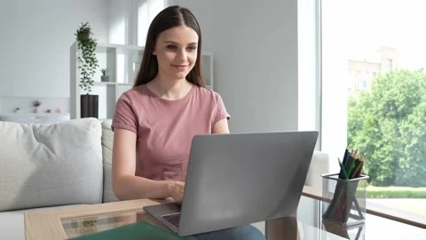 Concentrated agent lady sit couch use netbook app consult wi fi client room Stock Footage 165754128
