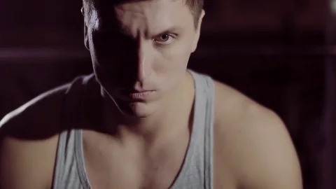 Concentrated athletic young man looking into the camera under artificial light Stock-Footage 72468224