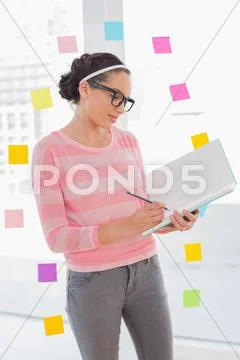 Concentrated attractive artist drawing on her sketchpad Stock Photos