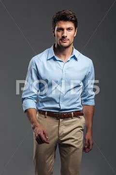 Concentrated attractive young manwalking and looking camera Stock Photos