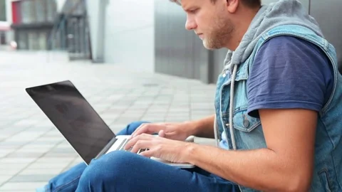 Concentrated Bearded Freelancer is Working on a Laptop in a City Park 스톡 동영상 82478898