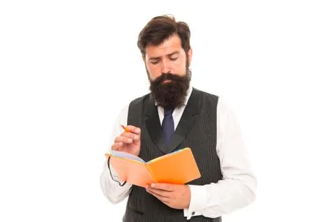 Concentrated bearded man write in school exercise book doing homework assignment Stock Photos
