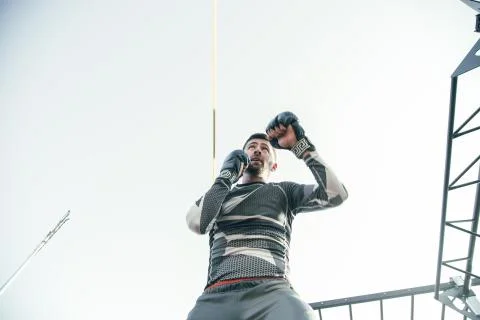 Concentrated boxer looking into the distance while standing outdoors Stock Photos