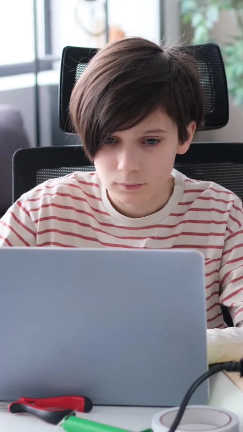 Concentrated Boy Doing Homework With Laptop And 3D Printer Stock Footage 303927950