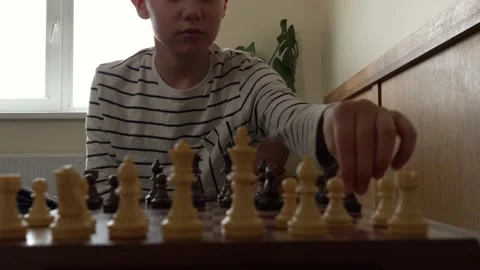 Concentrated boy learning to play chess with digital tablet computer. Education Stock Footage 153038926