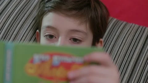 Concentrated boy reading a book, close-up Stock Footage 130392233