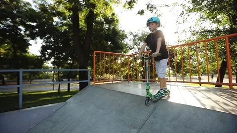 Concentrated boy stands on pool ramp edge and rides Stock Footage 114261983