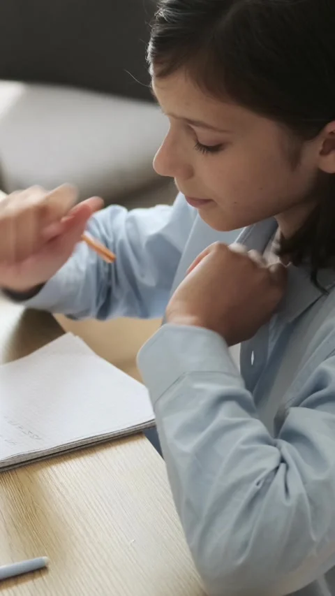 Concentrated Boy Writing Math Exercise In Notebook At Home Stock Footage 281860200