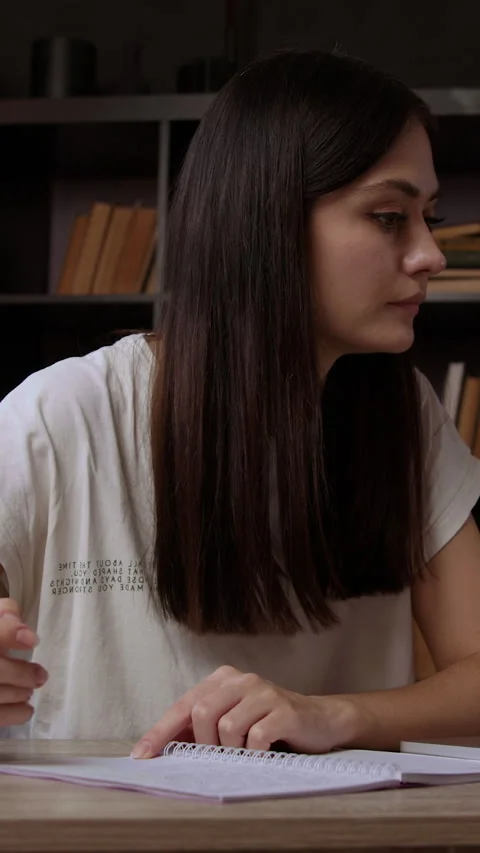 Concentrated brunette working at an office table in front of a computer. Young Video stock 305407595