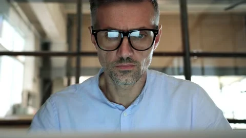 Concentrated business man looking at computer screen reflecting in glasses. Stock Footage 164102187