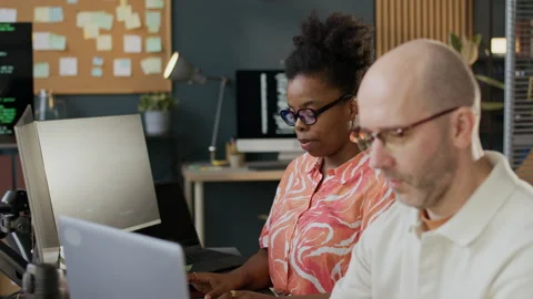 Concentrated Diverse Developers Coding on PC in Open Space Office Stock-Footage 306847335