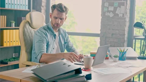 Concentrated doubtful suspicious manager work project read tables find bug Stock Footage 162028644
