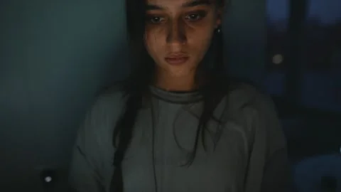 Concentrated female programmer under low lighting at her desk Stock Footage 323464128