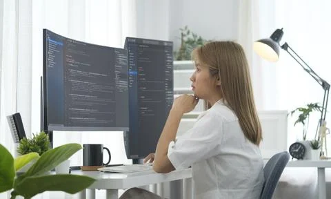 Concentrated  female software developer reading  analyzing data, programmin.. 스톡 사진